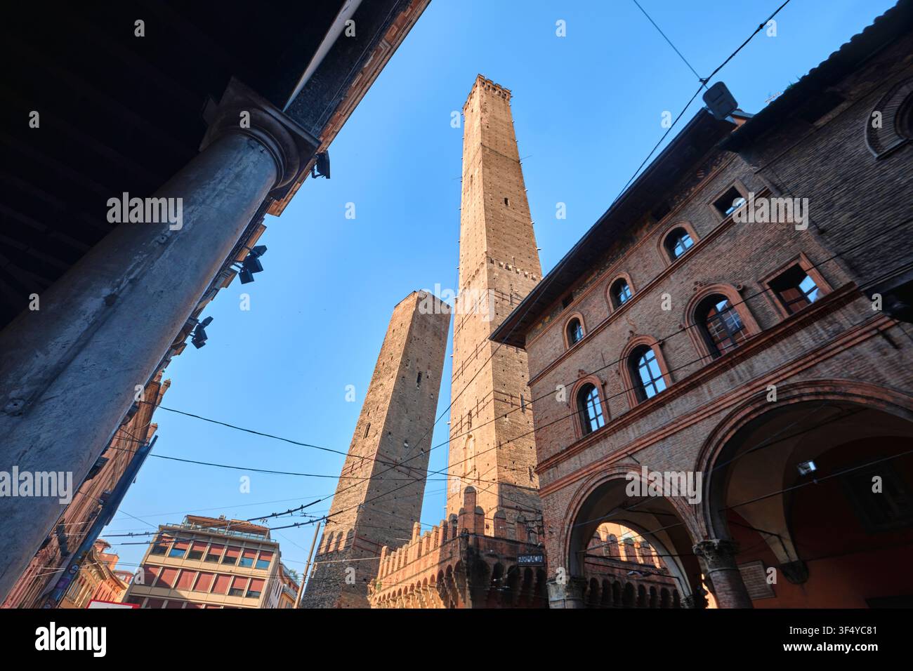Bologna, Italy - May 2026: Low angle perspective view of Asinelli and Garisenda Two Towers with portico Stock Photo