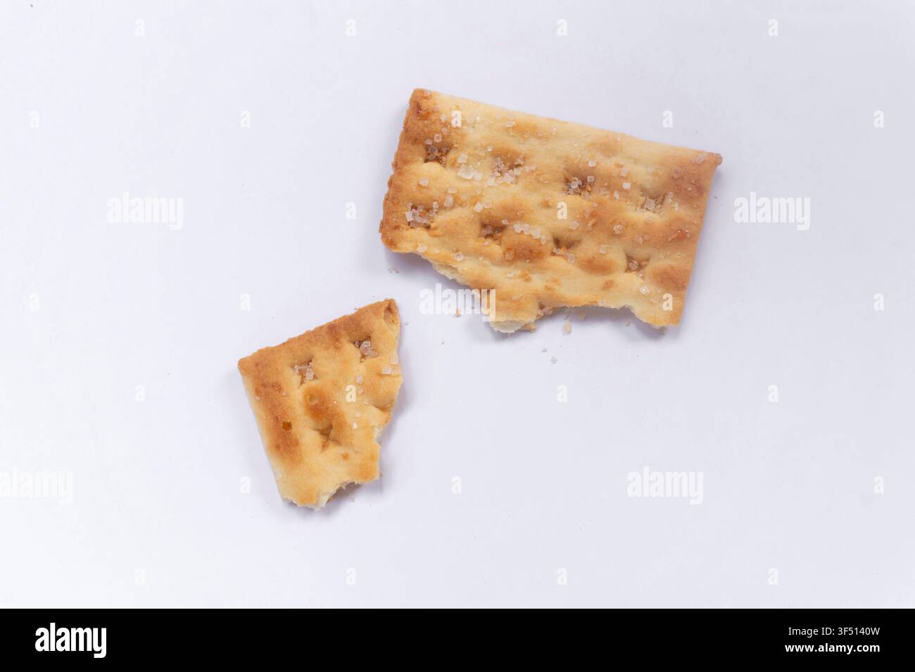 Broken Crispy Crackers on White Background Stock Photo