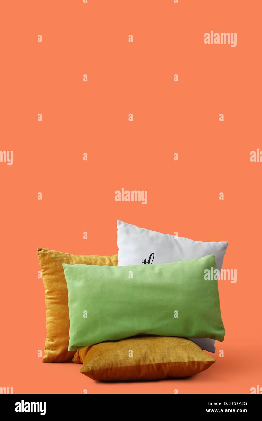 Decorative pillows on orange background Stock Photo