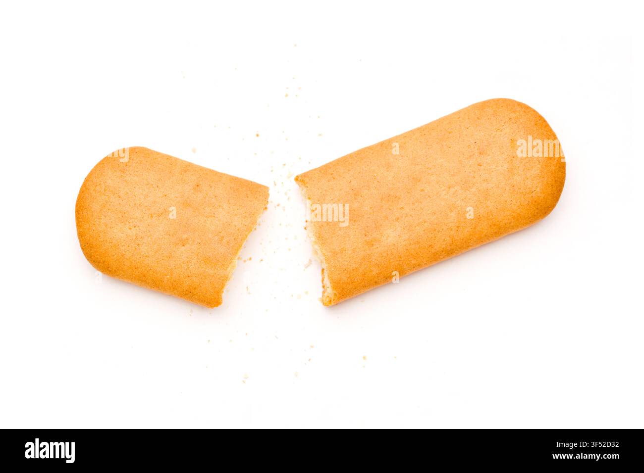 Broken golden rectangular cracker with scattered crumbs on white background Stock Photo