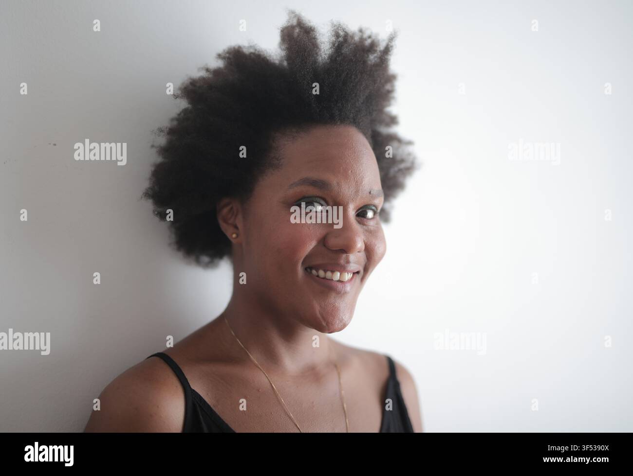 Friendly Black woman with an afro smiling brightly Stock Photo