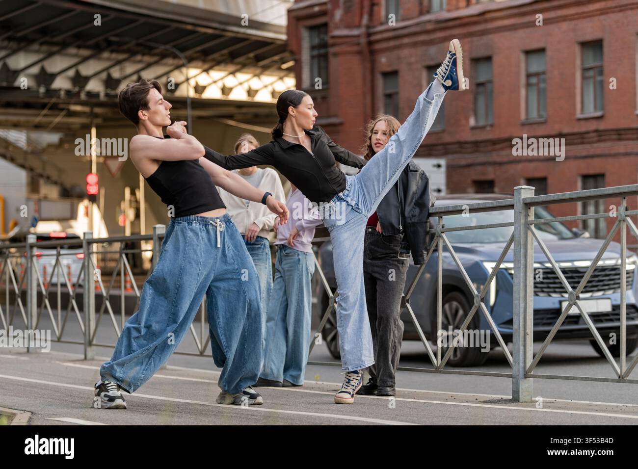 Flexible woman high kicking during a street dance Stock Photo