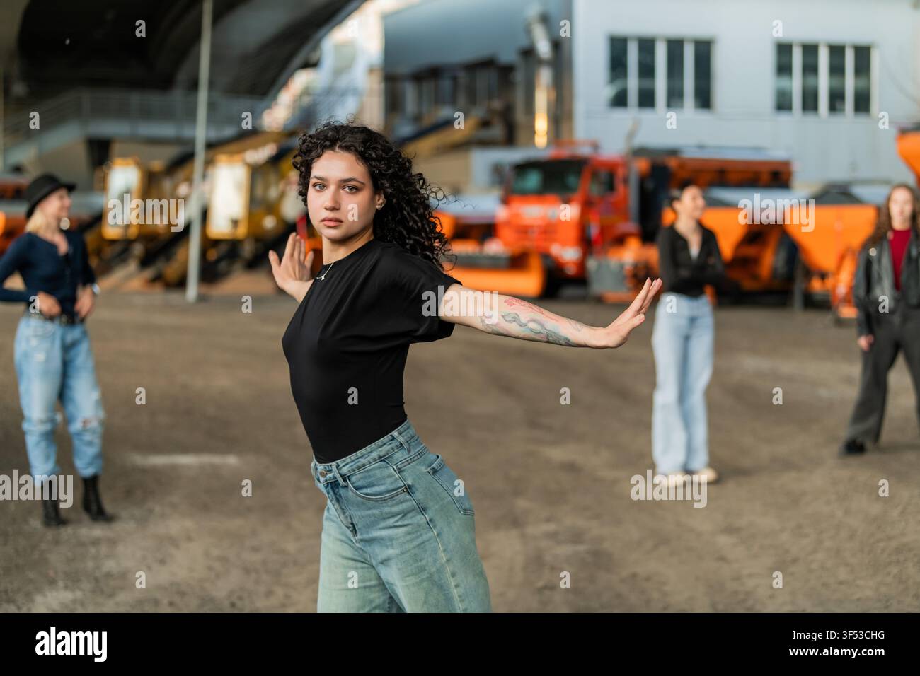 Focused woman poses while dancing with friends Stock Photo