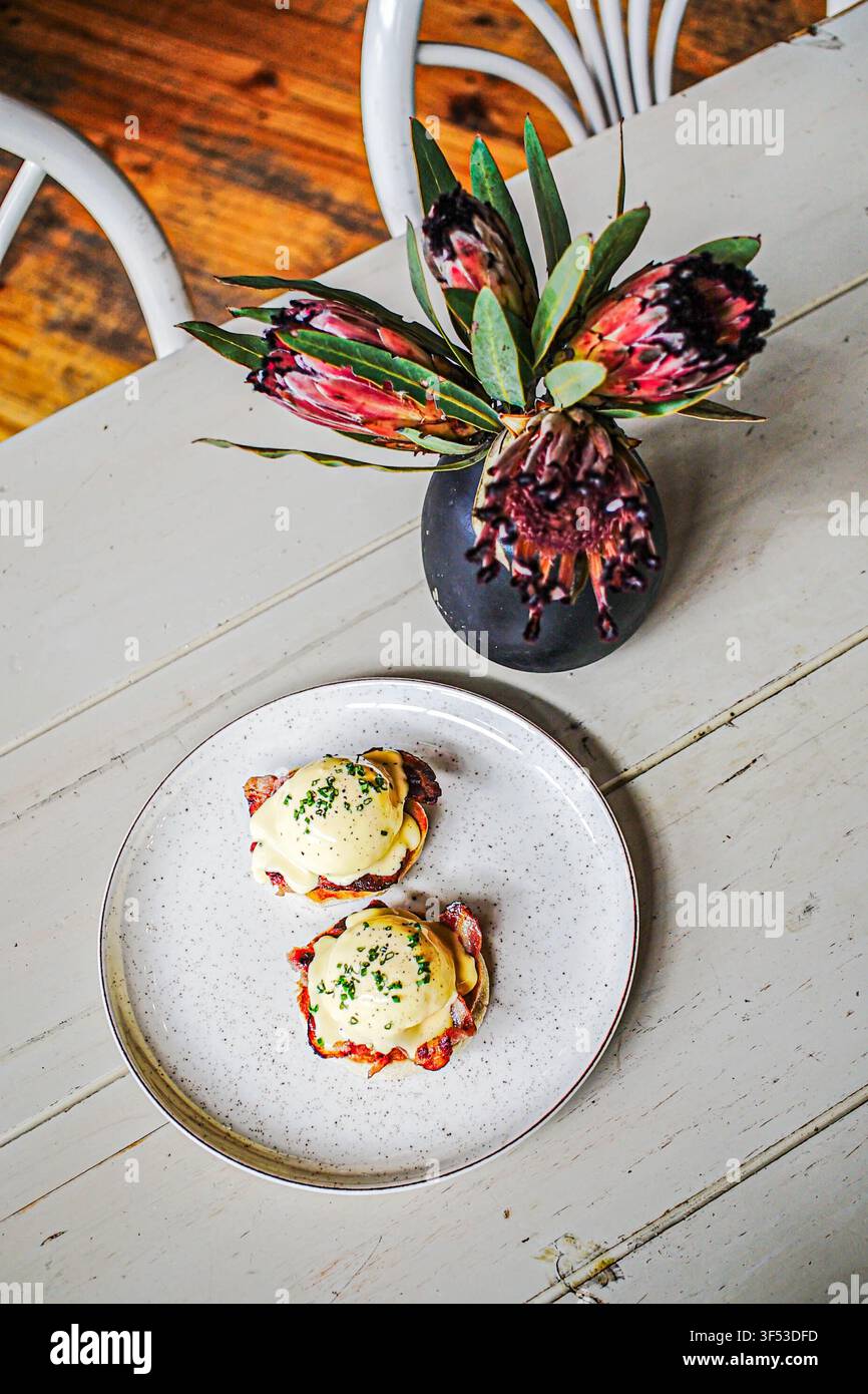 Delicious eggs Benedict brunch on a rustic white table Stock Photo