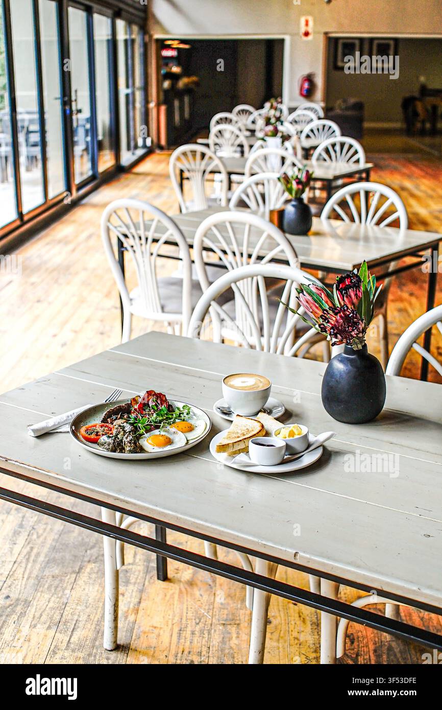Full breakfast meal served on a table in a rustic cafe Stock Photo