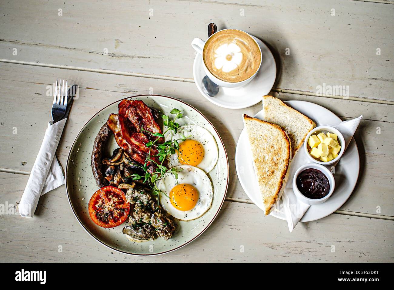 A full English breakfast with coffee on table Stock Photo
