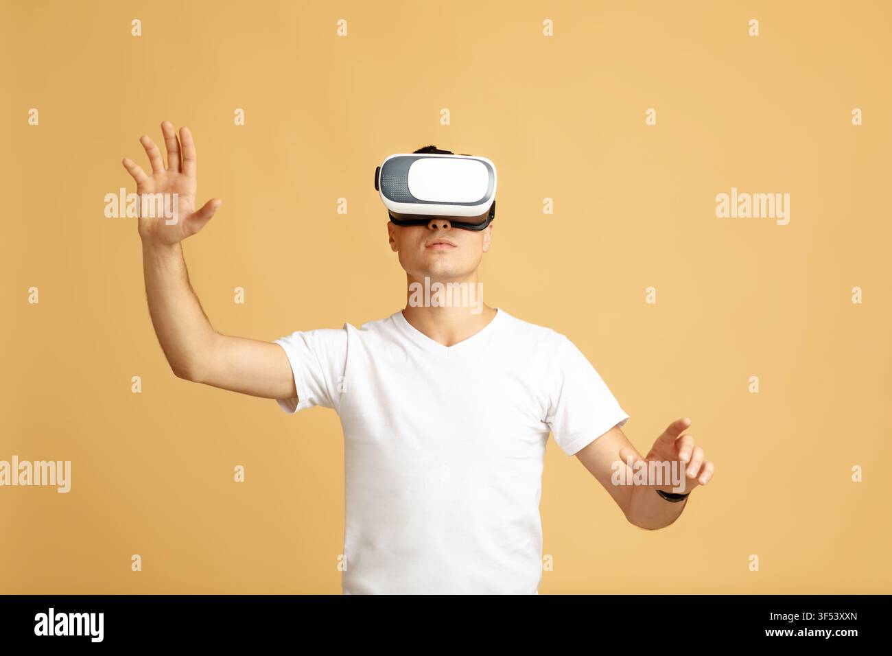 Guy in modern VR glasses exploring virtual reality Stock Photo
