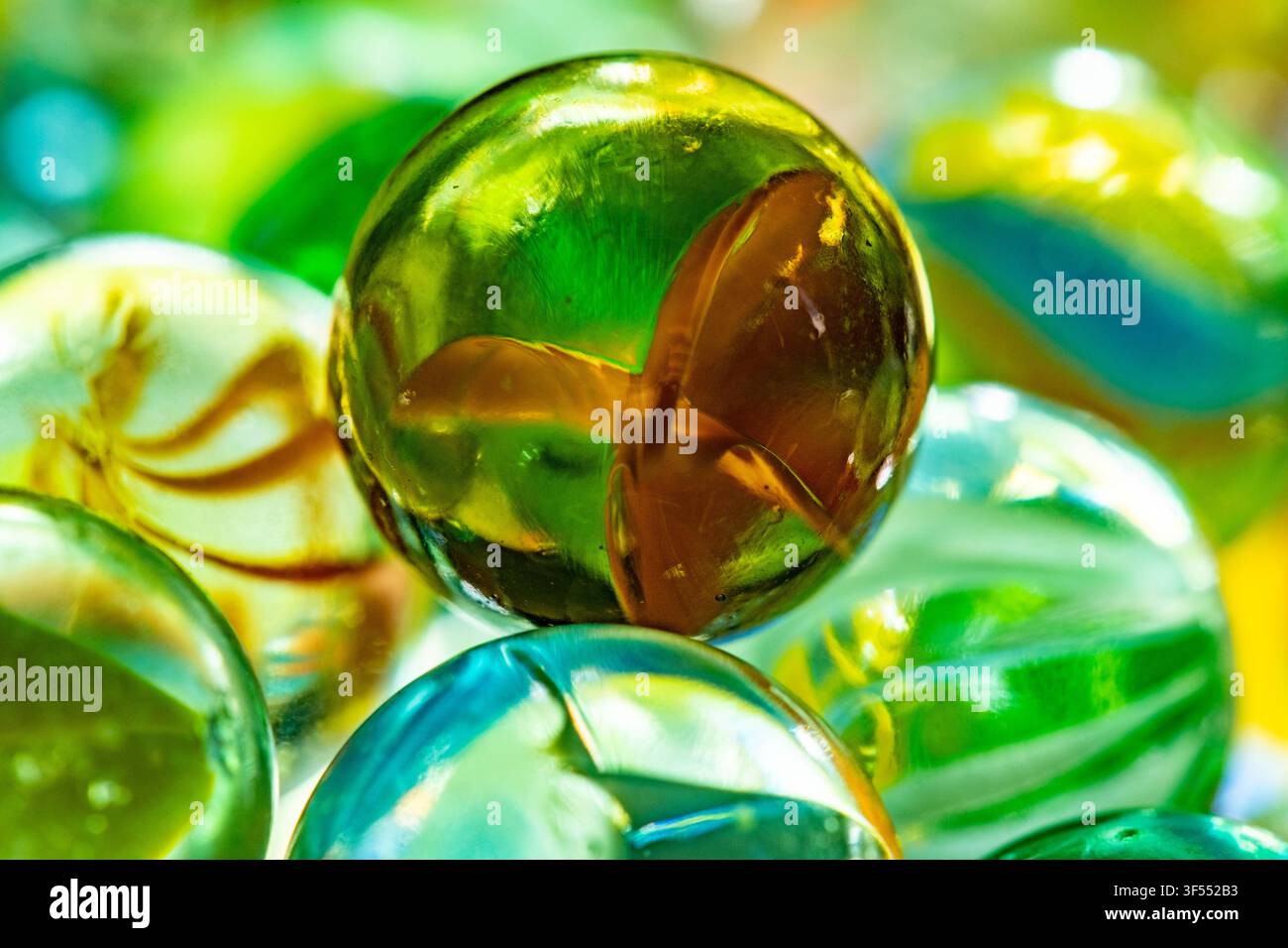 Glass marbles in various colors creating a vibrant background texture Stock Photo