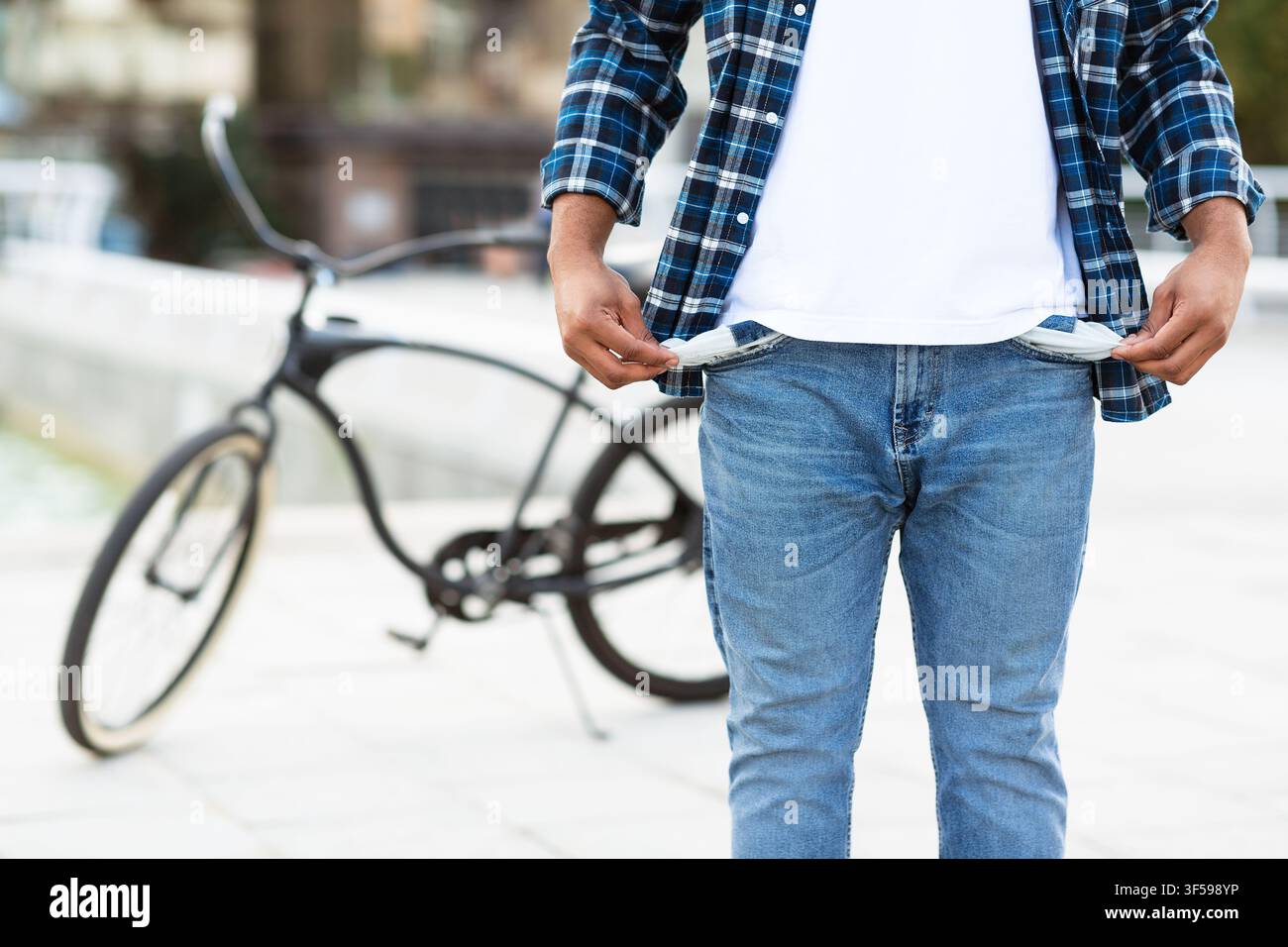 African guy showing his empty pockets outdoors Stock Photo