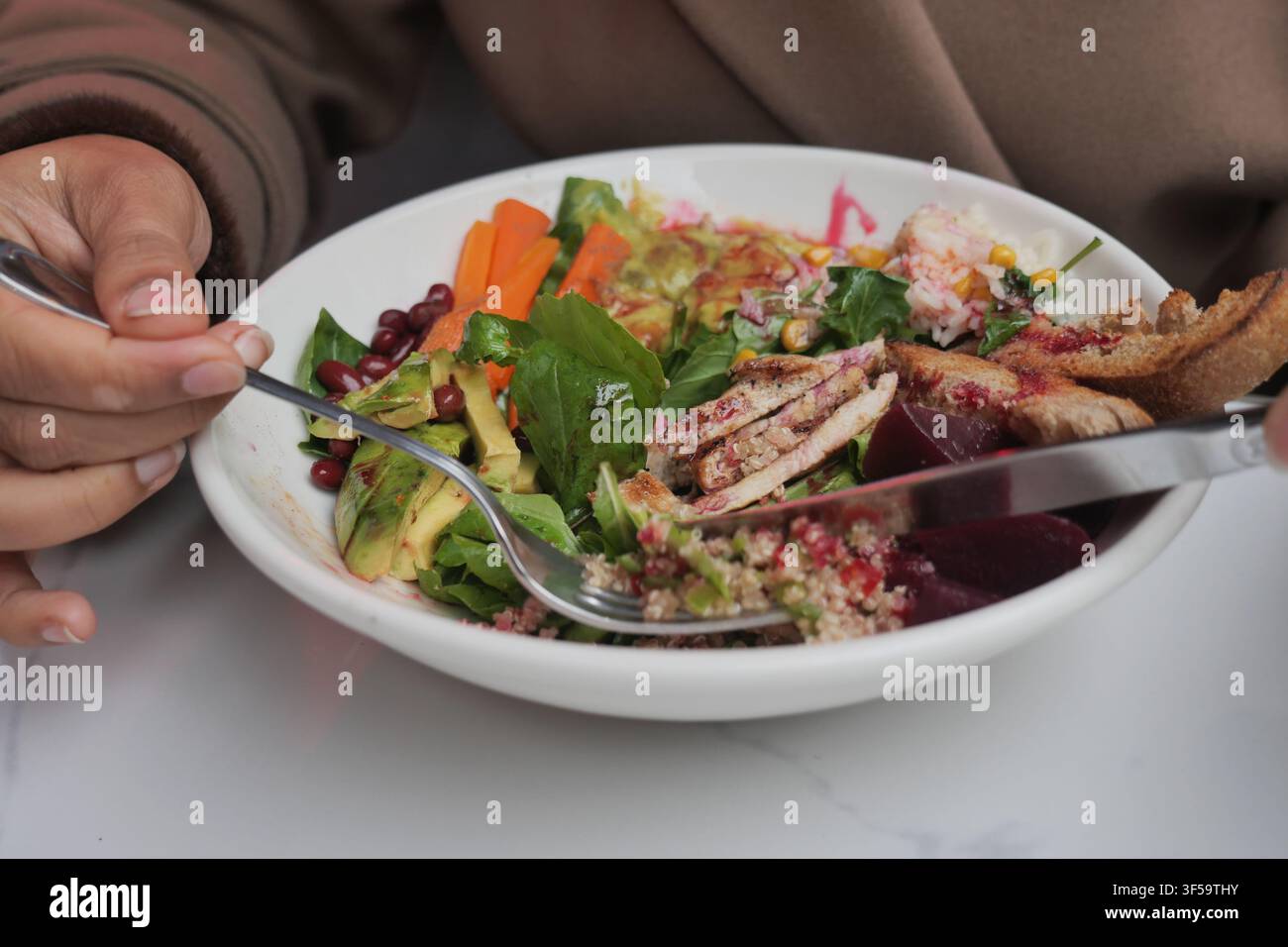Healthy meal with salad and chicken on a white plate Stock Photo