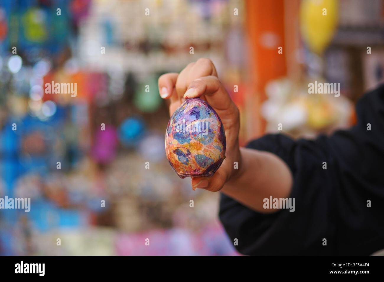 hand-painted or dyed Easter egg, likely decorated using a marble effect technique Stock Photo