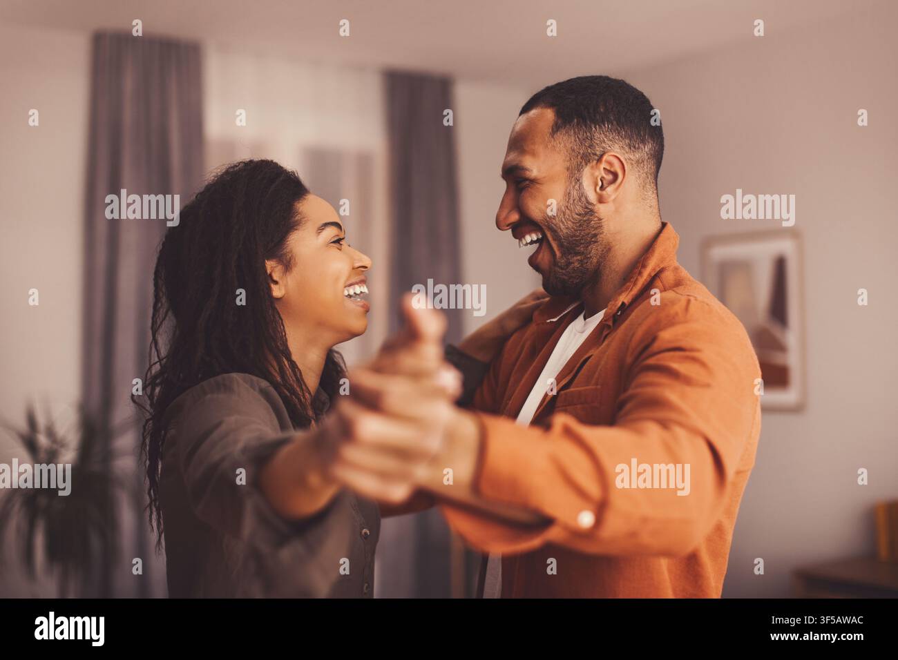 Happy Black Couple Enjoying Dancing Together At Home, Close Up Lifestyle Moment Stock Photo