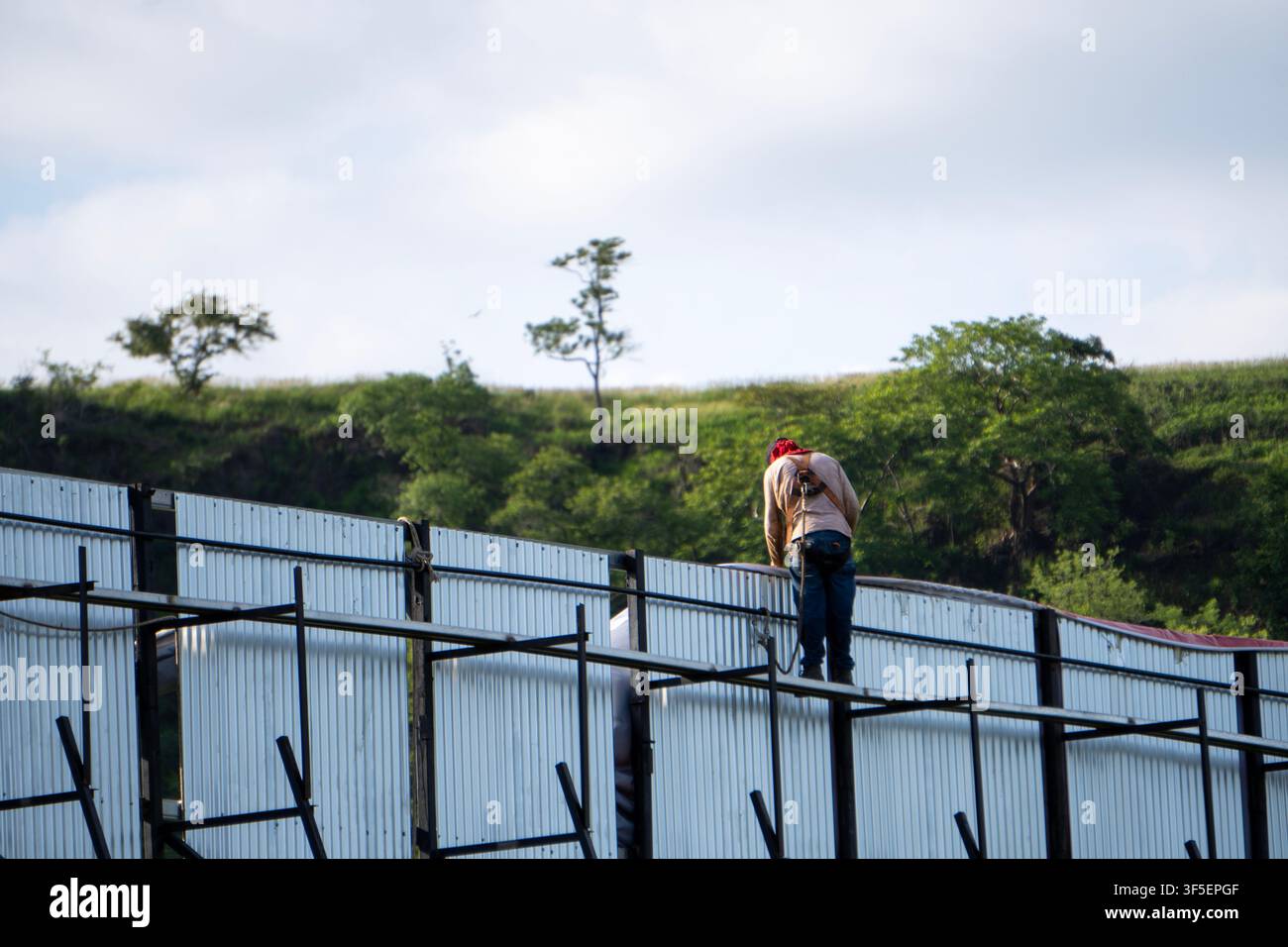 Man working on external billboard structure Stock Photo
