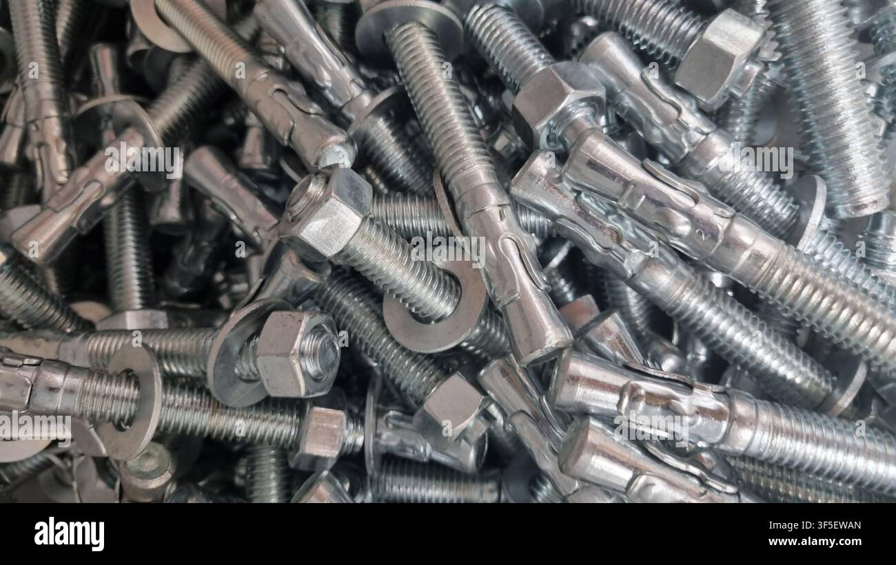 Texture of bolts and nuts in bulk. Stock Photo