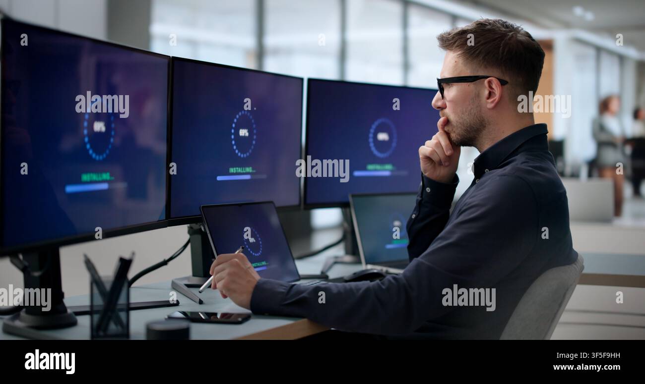 Man Installing New Software Update On Laptop To Fix Slow Loading. Stock Photo