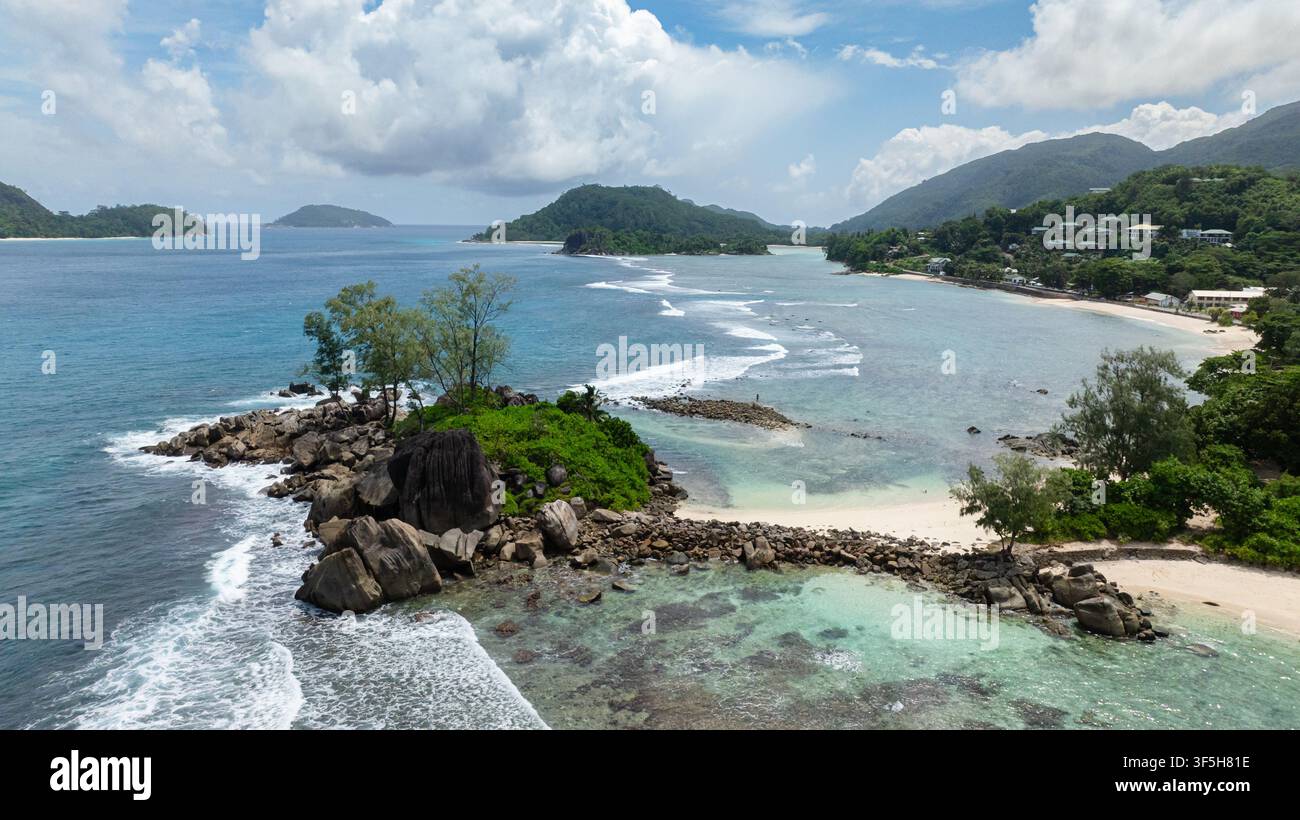 Beach with white sand, crystal-clear waters and tropical foliage. Seychelles, Mahe. Stock Photo