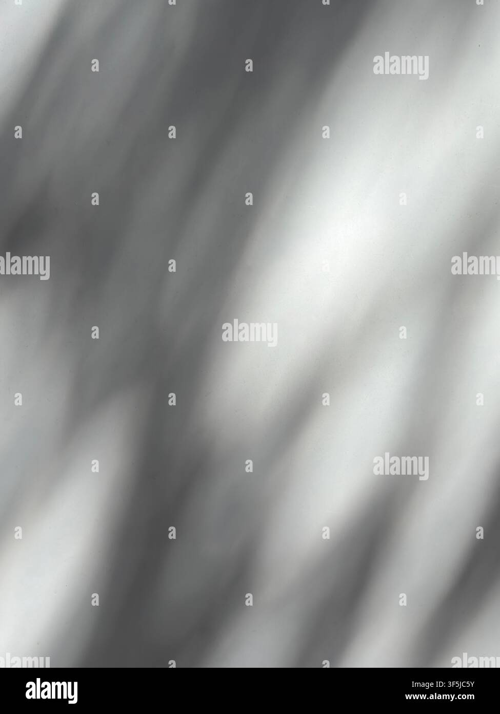 Soft abstract background with blurred gray and white diagonal light streaks, creating a subtle monochrome texture with gentle shadows, highlights, and Stock Photo