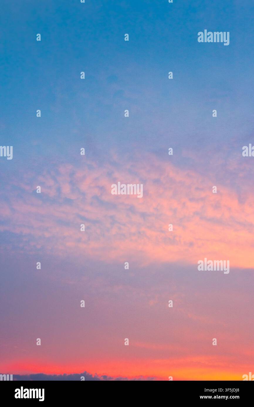 sky at sunset for background. red clouds on the blue sky. nature backdrop in evening light Stock Photo