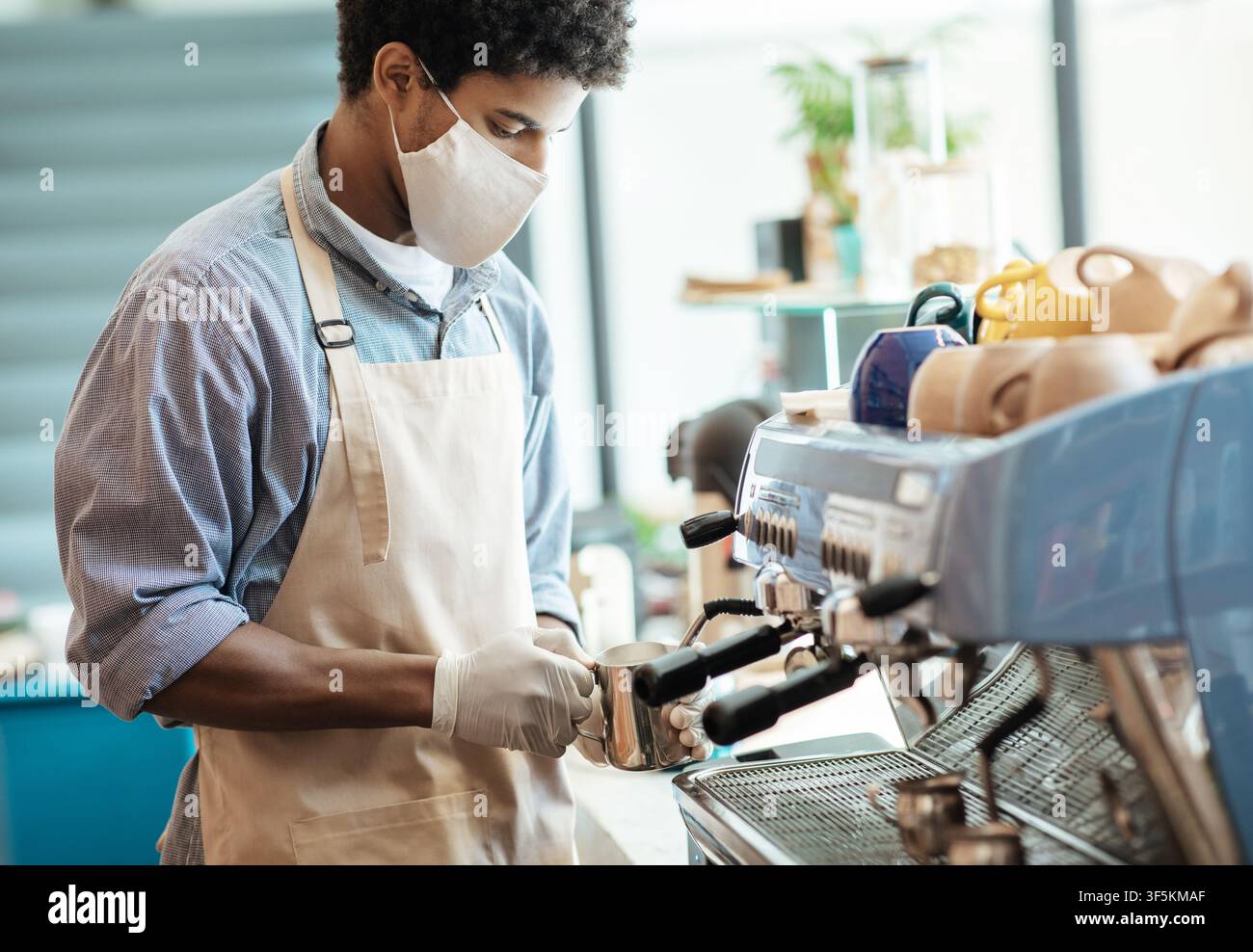 COVID-19 pandemic and small business, barista work during social distancing Stock Photo