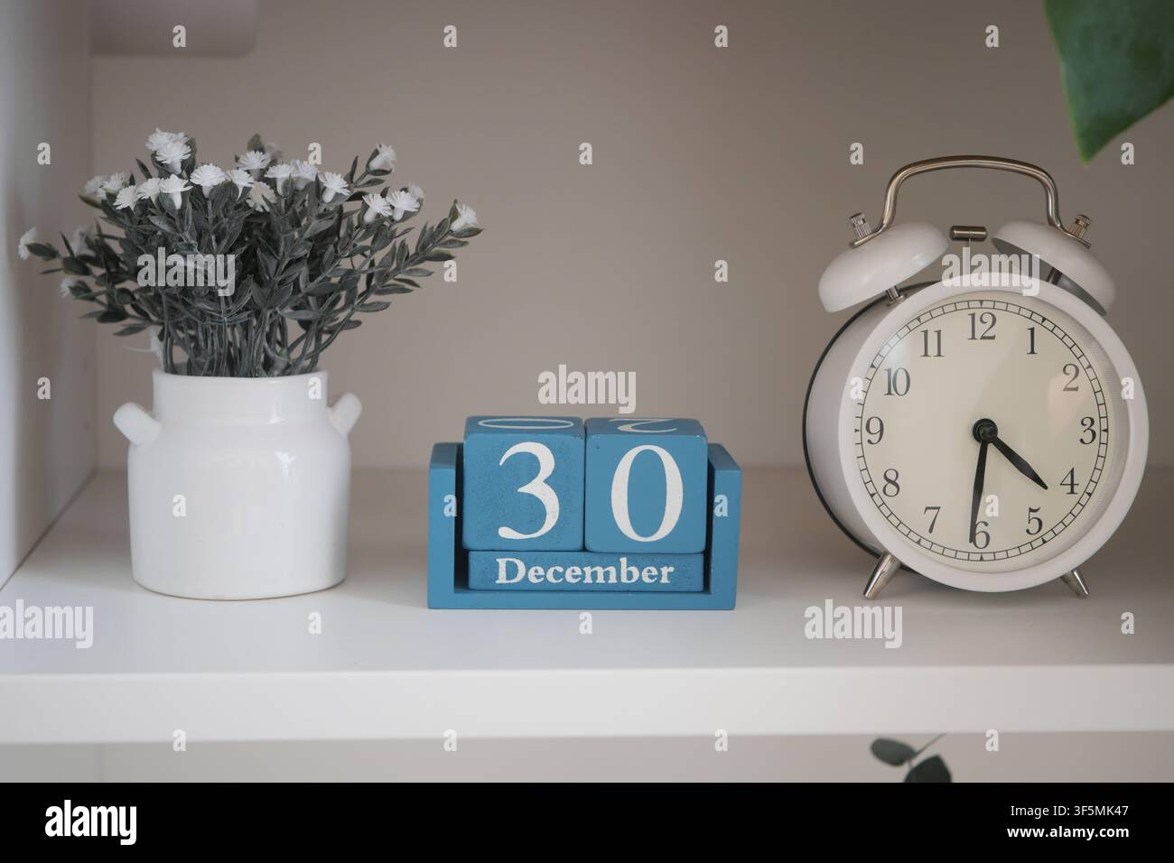 Decorative clock and calendar display on a shelf Stock Photo