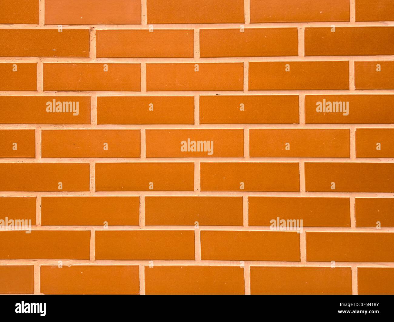 Clean orange brick wall texture background with regular pattern Stock Photo