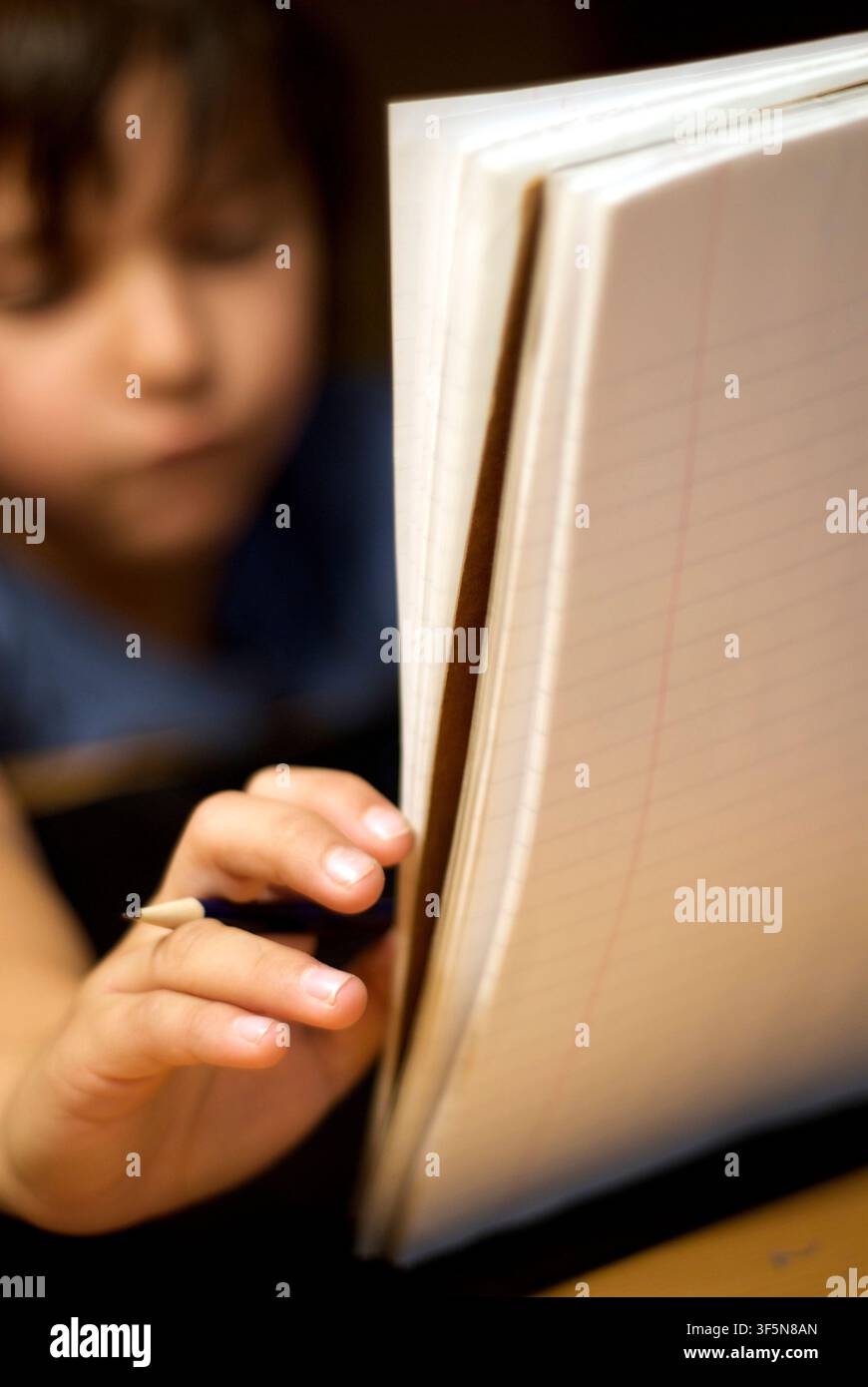 7-year old first grader doing his homework. Stock Photo
