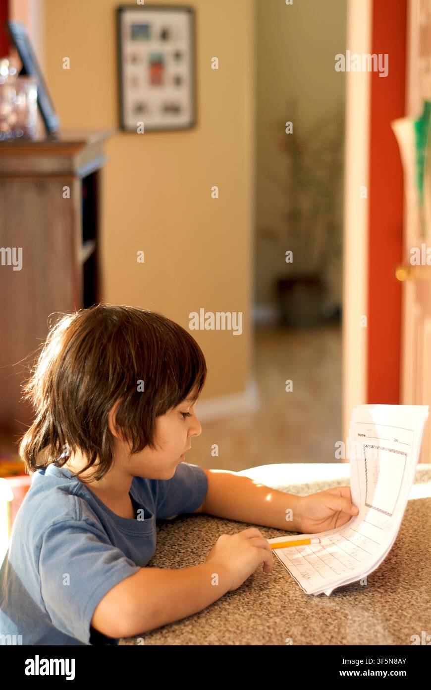 7-year old first grader doing his homework. Stock Photo