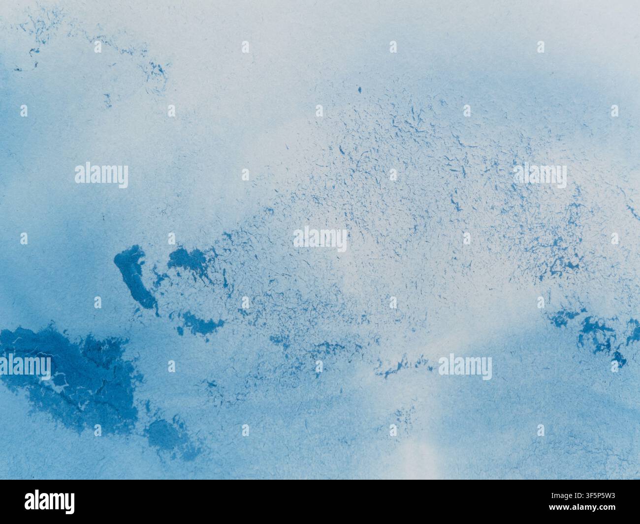 Abstract blue watercolor texture. Bright blue pigments spread naturally across the paper, creating a vibrant freeform pattern. Stock Photo