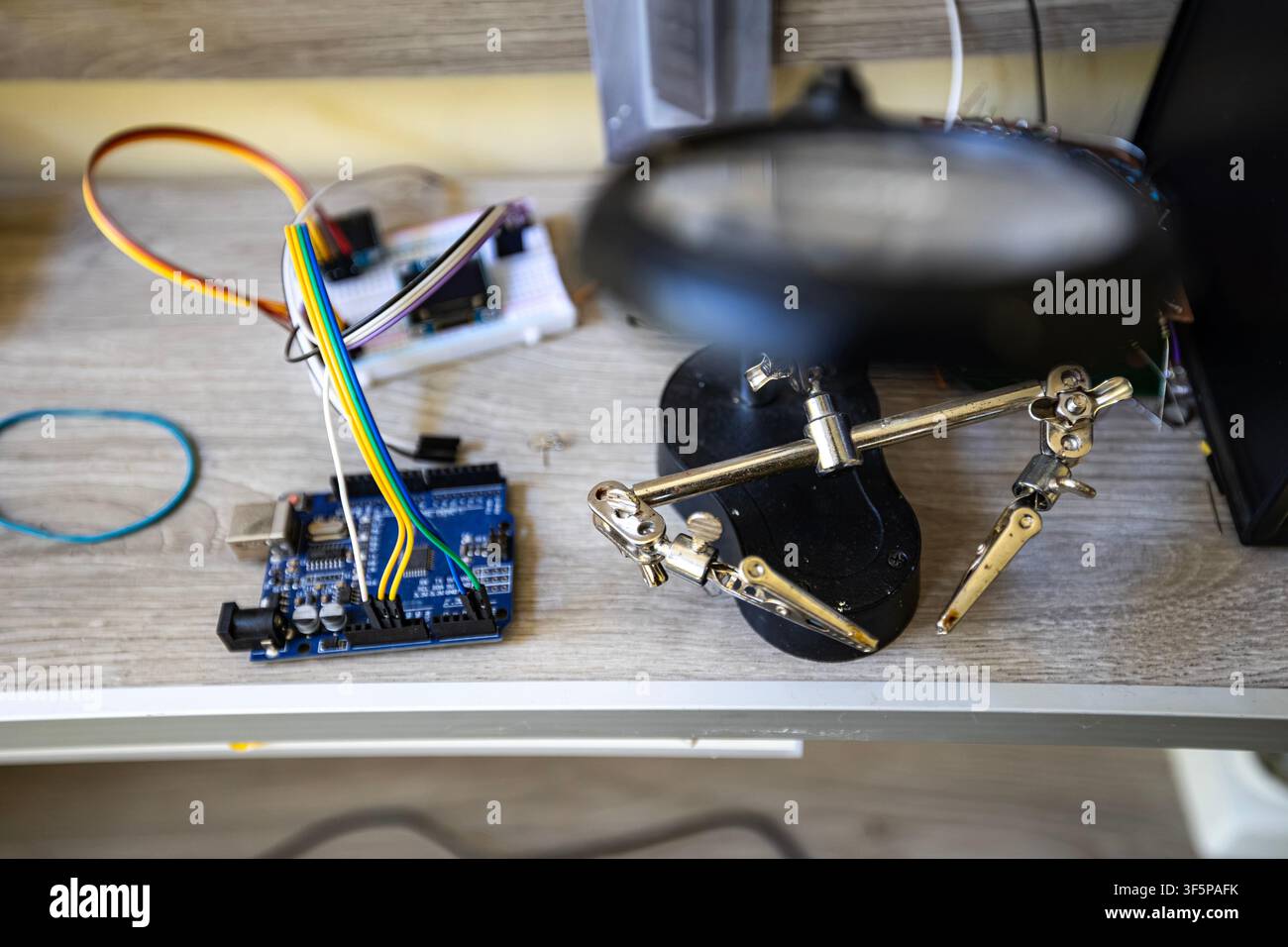 Electronic prototyping tools and hardware components on a workshop desk Stock Photo