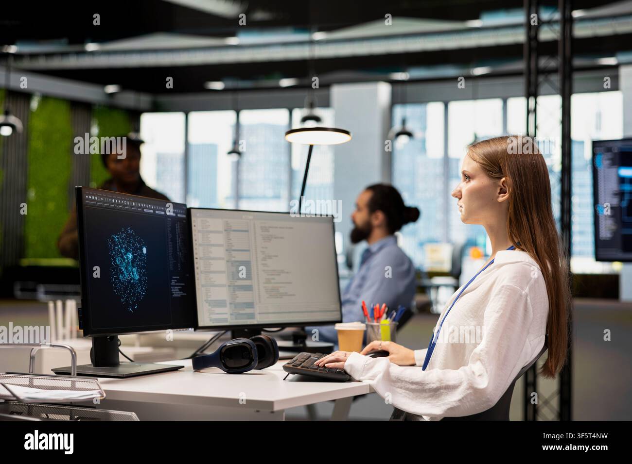 Junior programmer using machine learning AI LLM chatbot, optimizing company systems performance. Young female engineer using artificial intelligence assistant to automate scripts Stock Photo
