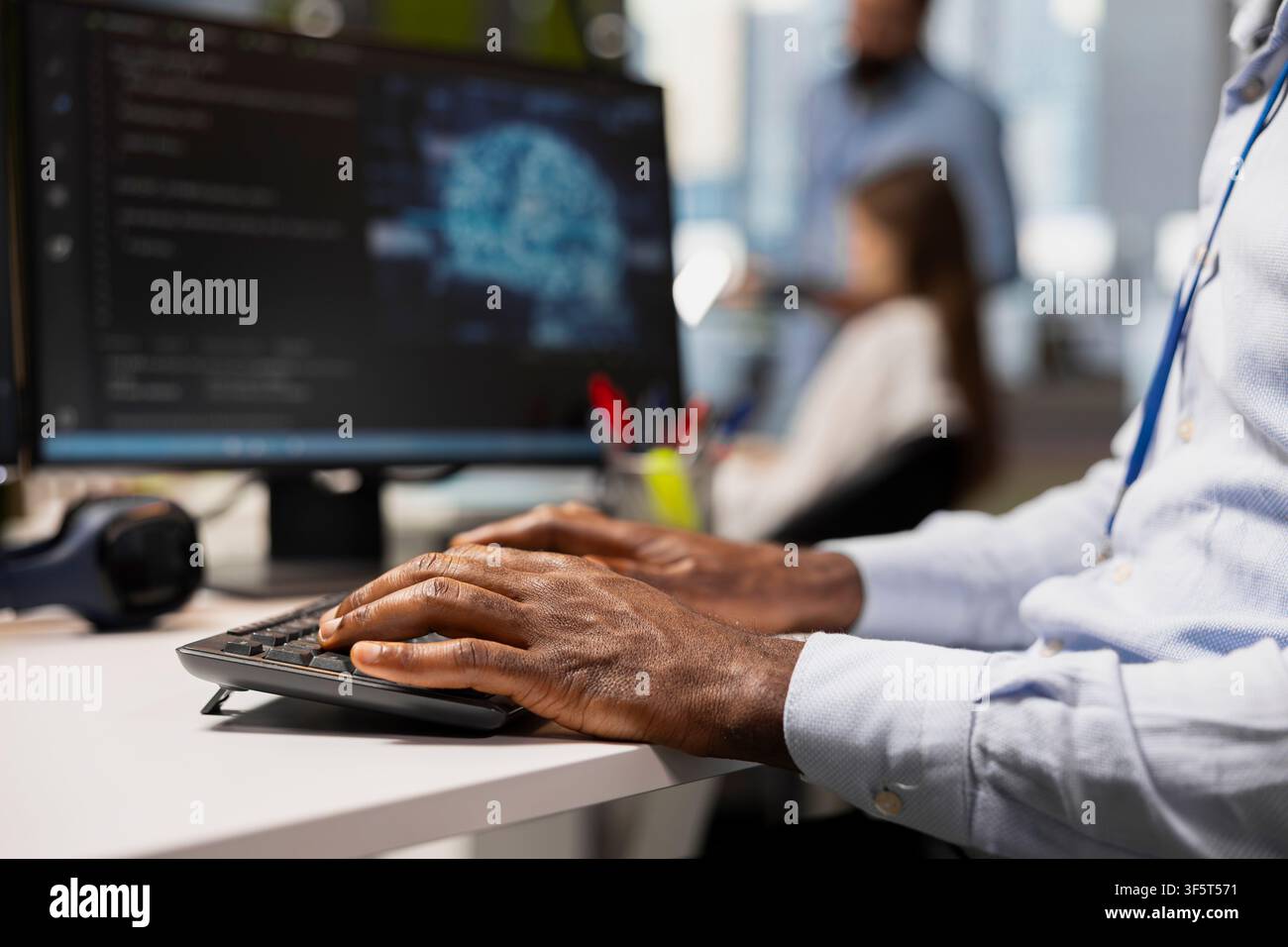 Close up of computer scientist writing code, developing neural networks APIs. Startup office worker troubleshooting application errors using AI technology on PC, typing on keyboard Stock Photo