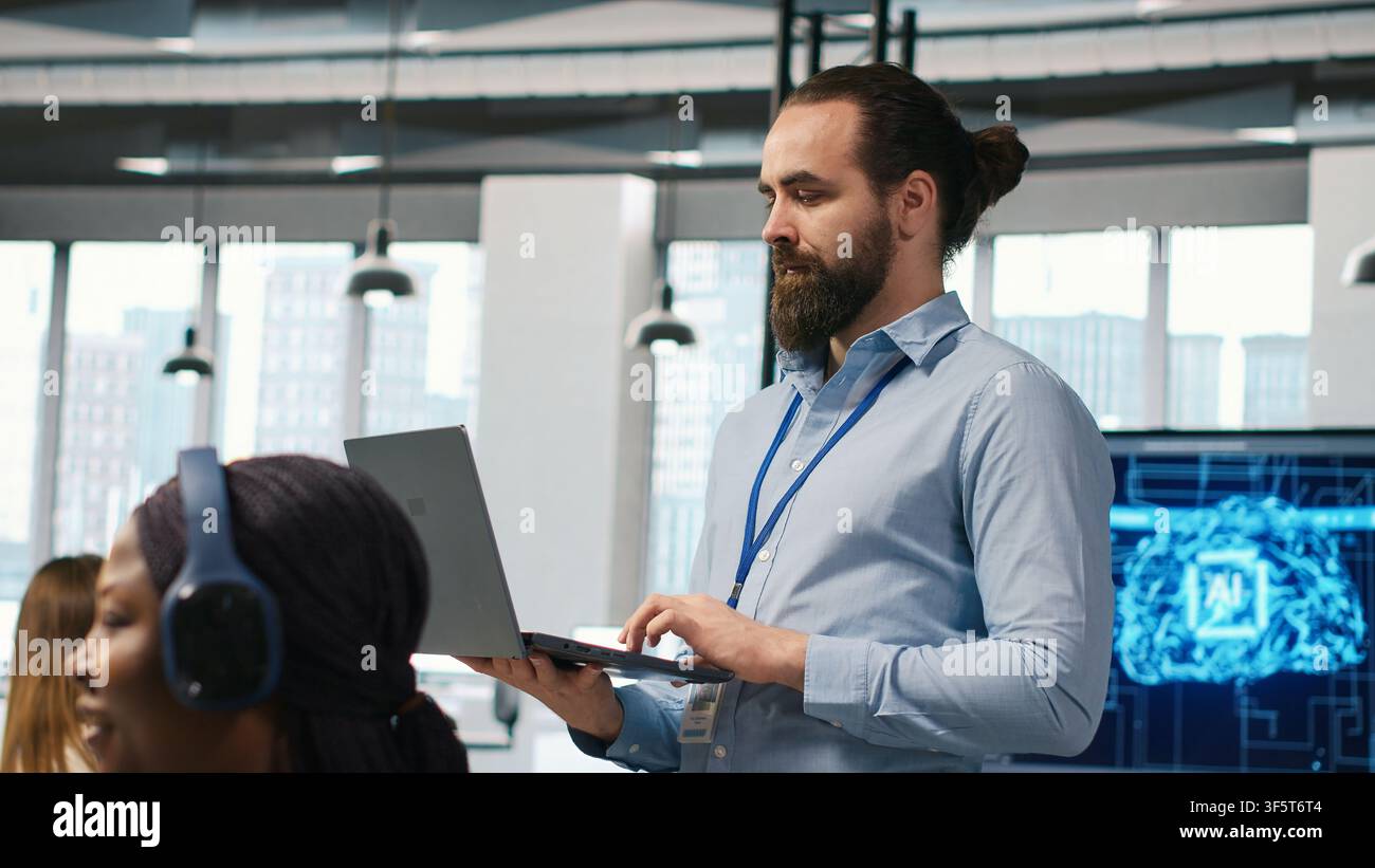 Team of programmers in office developing software applications, integrating AI driven automation in operations. Developers at work debugging applications to resolve issues, camera A Stock Photo