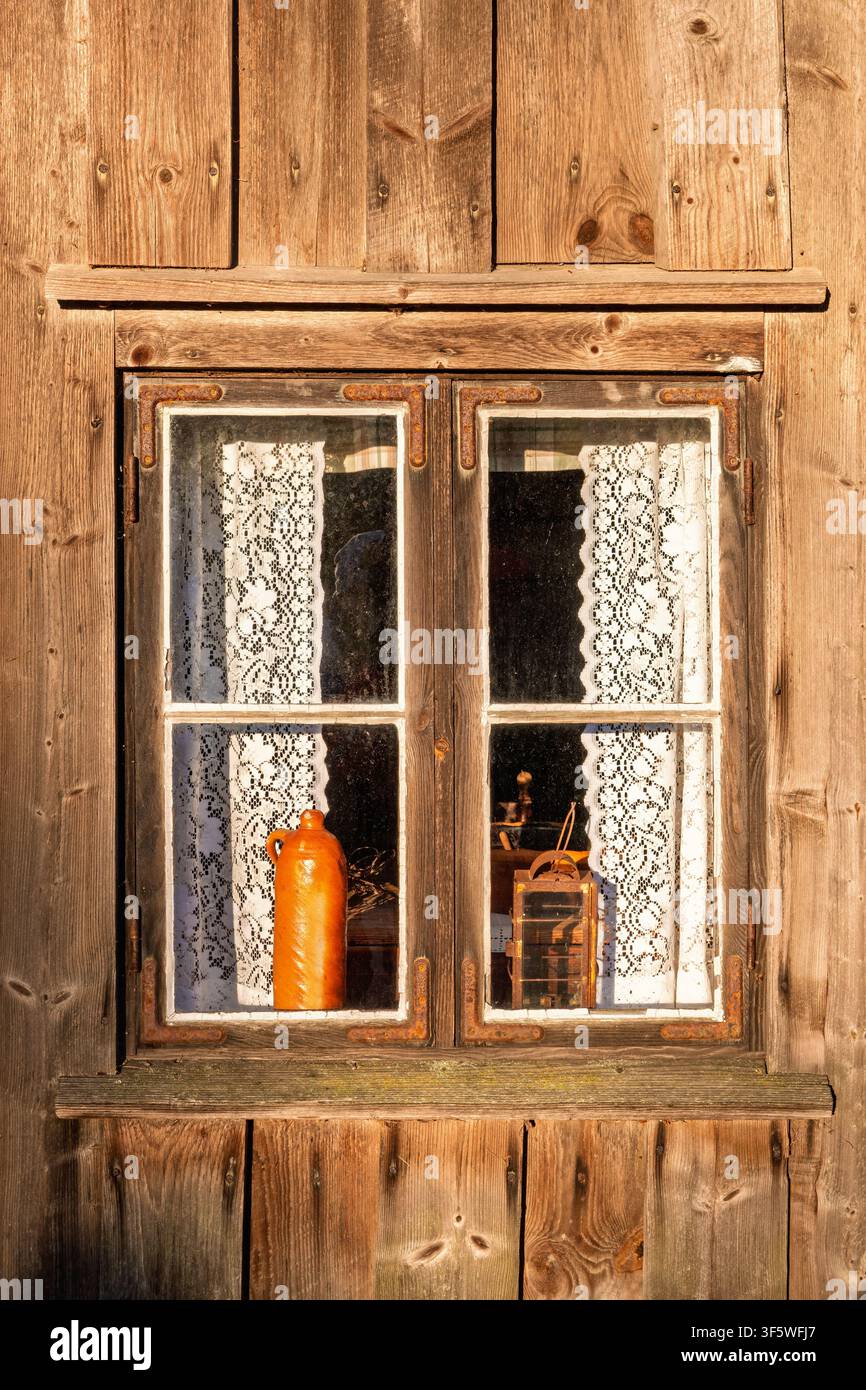 Rustic wooden croft window with lace curtains Stock Photo
