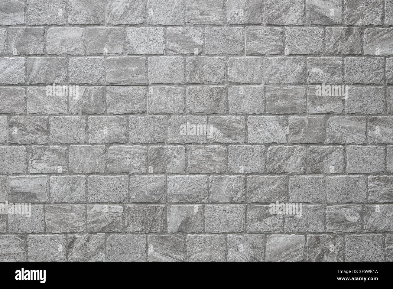 gray and white stone brick wall for pattern and background. Stock Photo