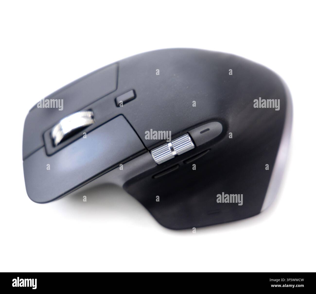 A modern ergonomic wireless computer mouse is isolated against a clean white background Stock Photo