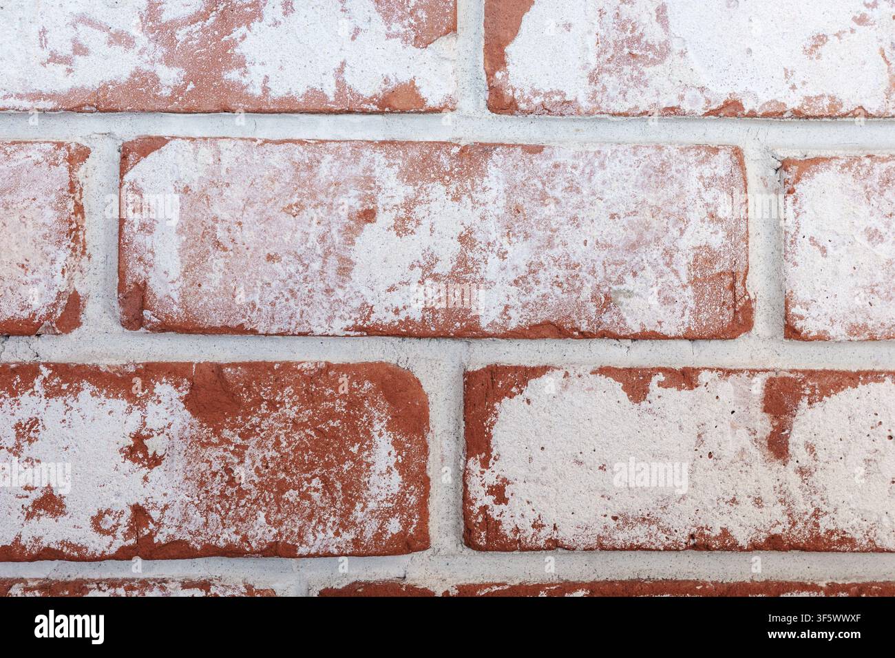 Whitewashed red brick wall, weathered plaster texture and rustic masonry background for construction, renovation, industrial interiors and architectural design. Stock Photo