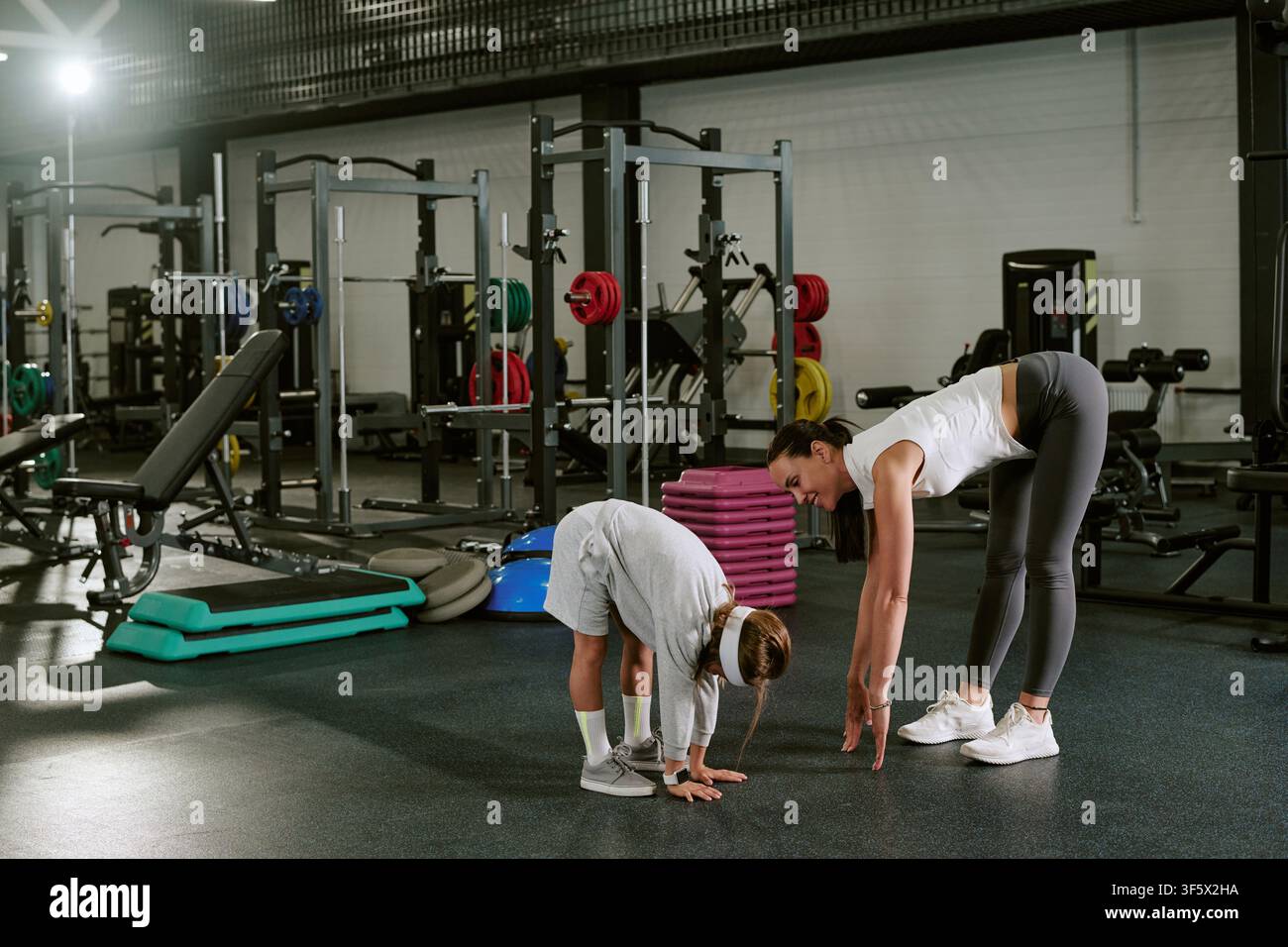 Young Stretch Routine Fitness smile stretching woman hi-res stock photography and images - Alamy