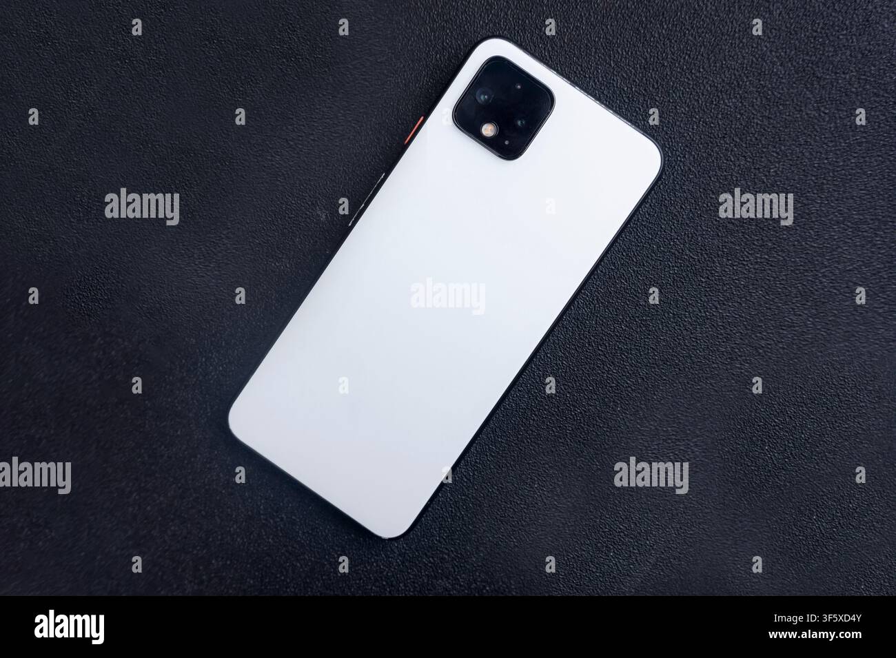 White Smartphone on Black Surface Background Stock Photo