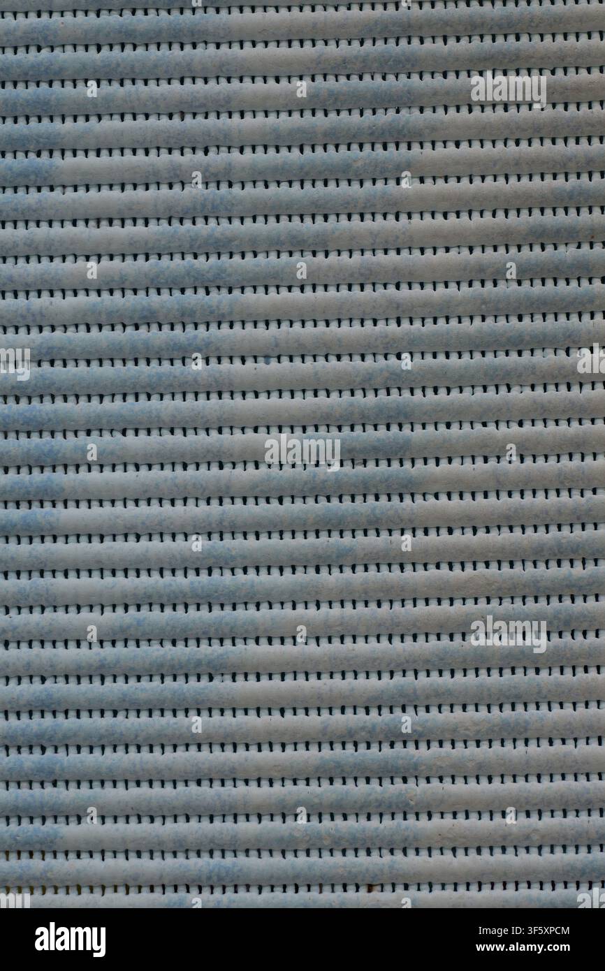 Gray blue textured surface with horizontal stripes and repeating structure. Stock Photo