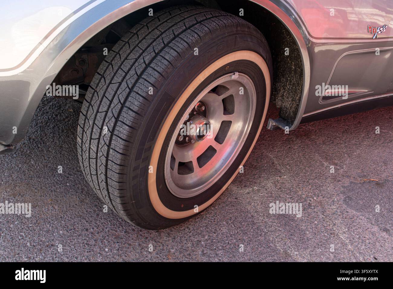 Tavernes Blanques, Spain - June 14, 2026. The aluminum wheel rim and whitewall tire are shown clearly with the anniversary fender badge on a silver Ch Stock Photo