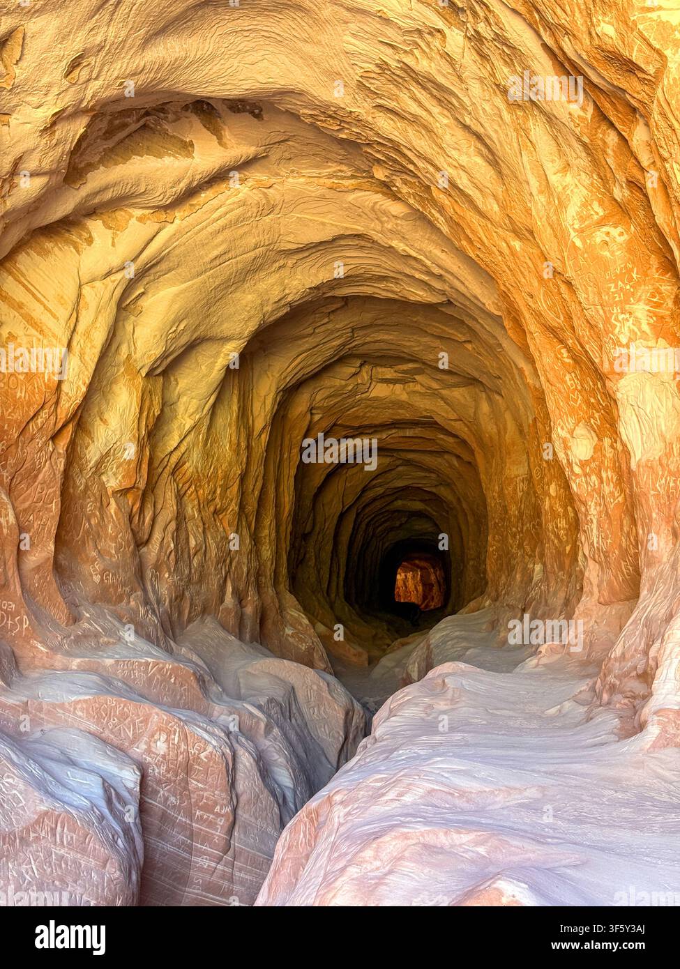 Entrance to the hiking trail through the Belly of the Dragon near Kanab, which is a man-made drainage tunnel with sandstone rock smoothed by water - Smartphone Captured Stock Image