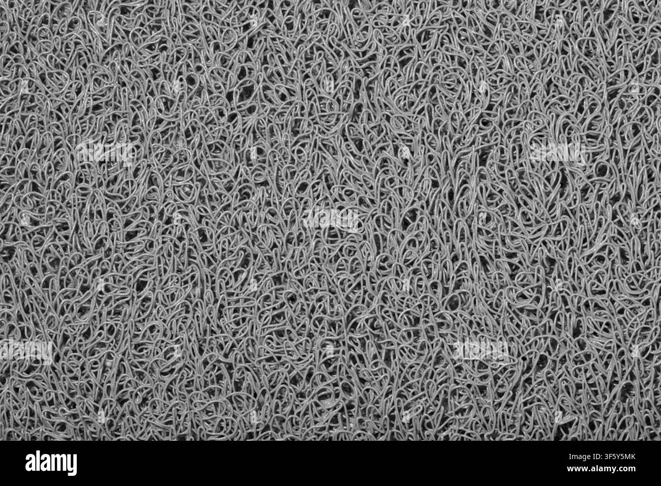 Gray background wavy fibers plastic string material texture black and white. Stock Photo