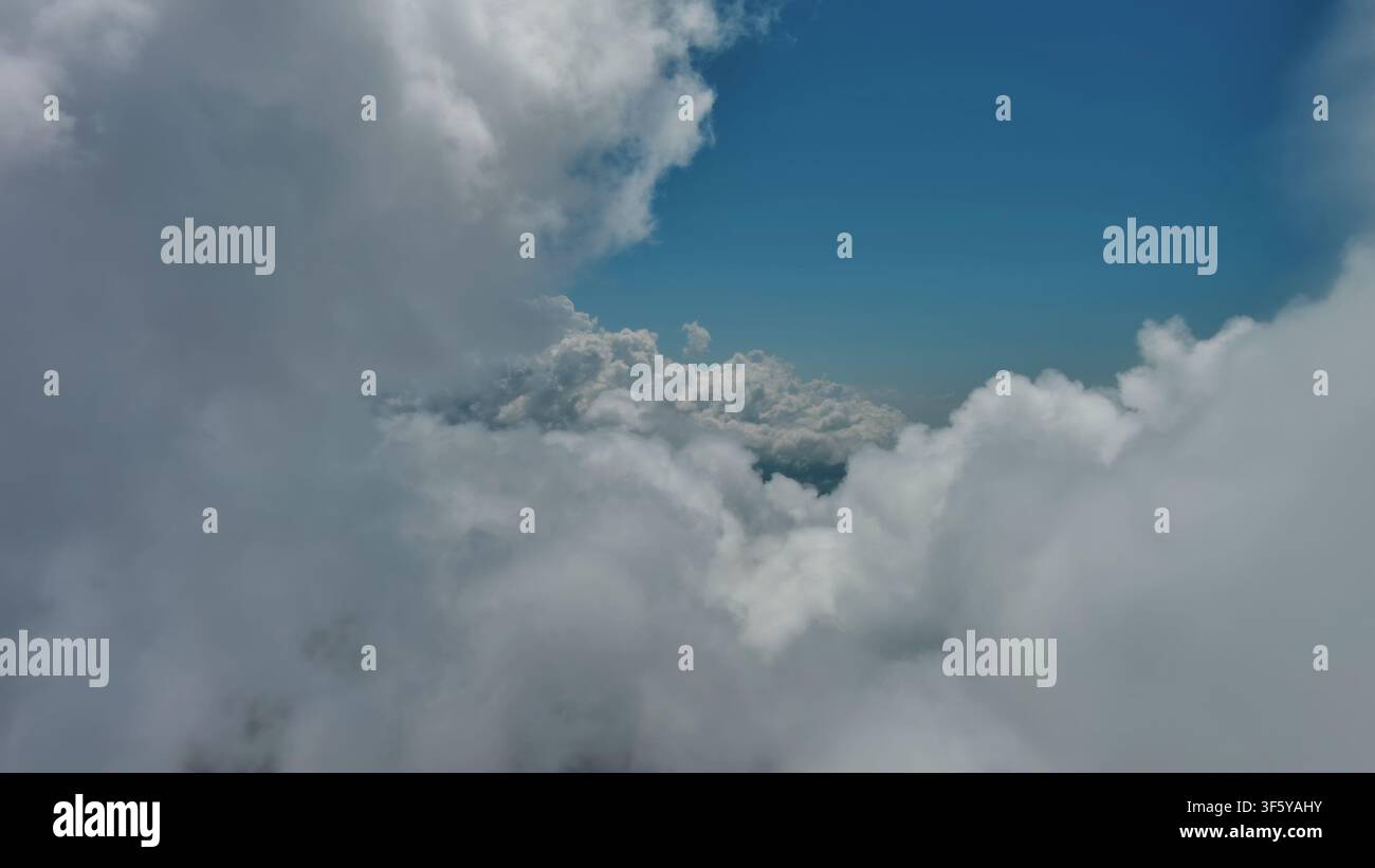 Flying through white fluffy clouds Stock Photo