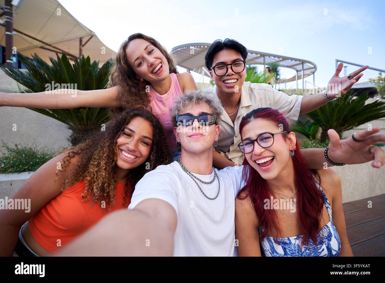 Group of happy young friends taking a selfie outdoors. Stock Photo