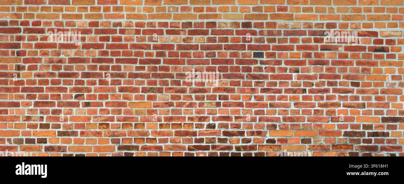 Old red brick wall, partly with some dark bricks Stock Photo