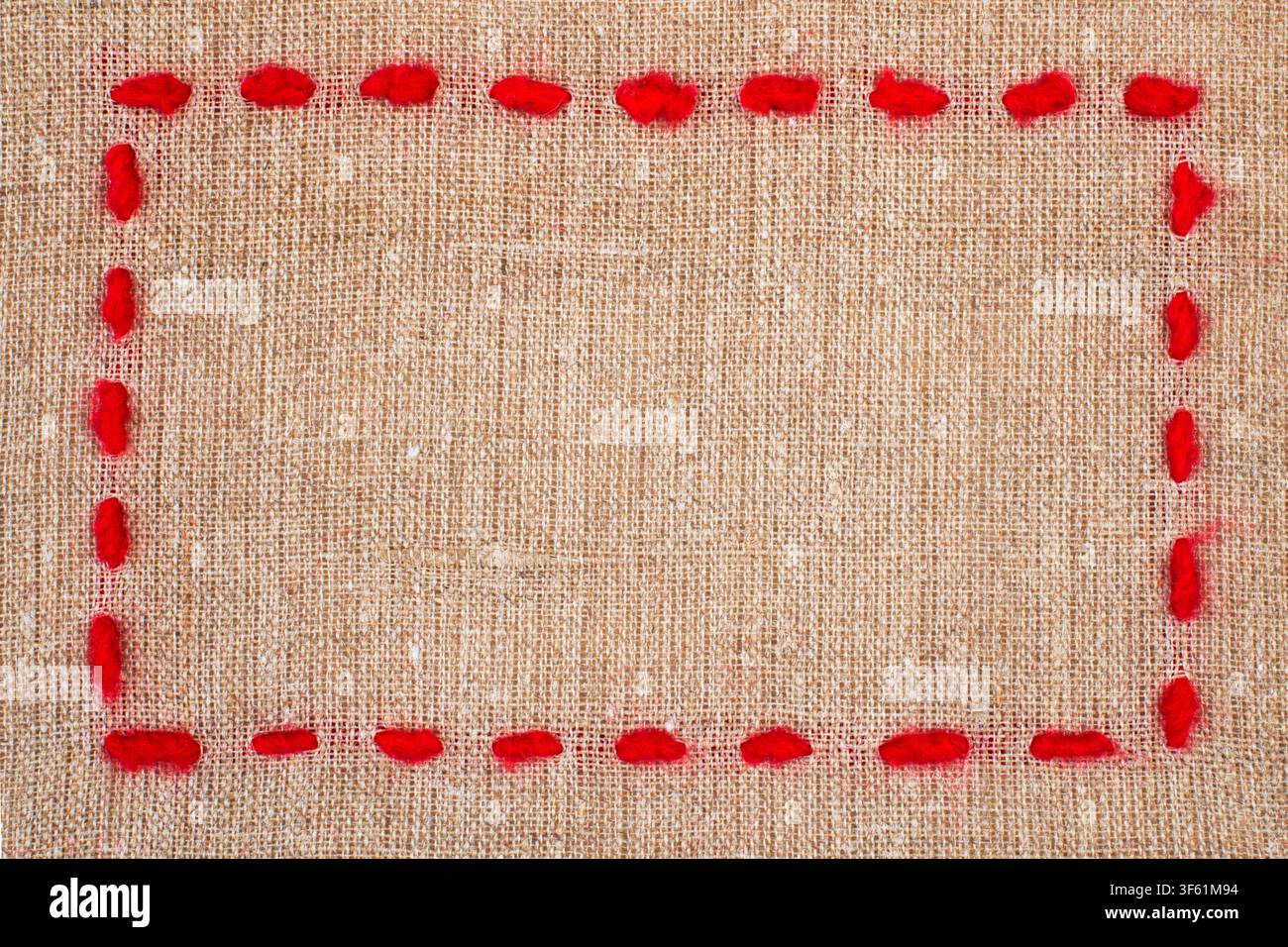 Red Yarn Frame on Burlap Texture Background Stock Photo