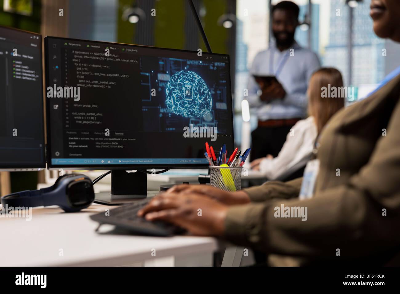 Close up of programmer in office typing on keyboard, using AI to streamline app development. IT specialist writing code at desk using PC to run debugging programs with machine learning technology Stock Photo
