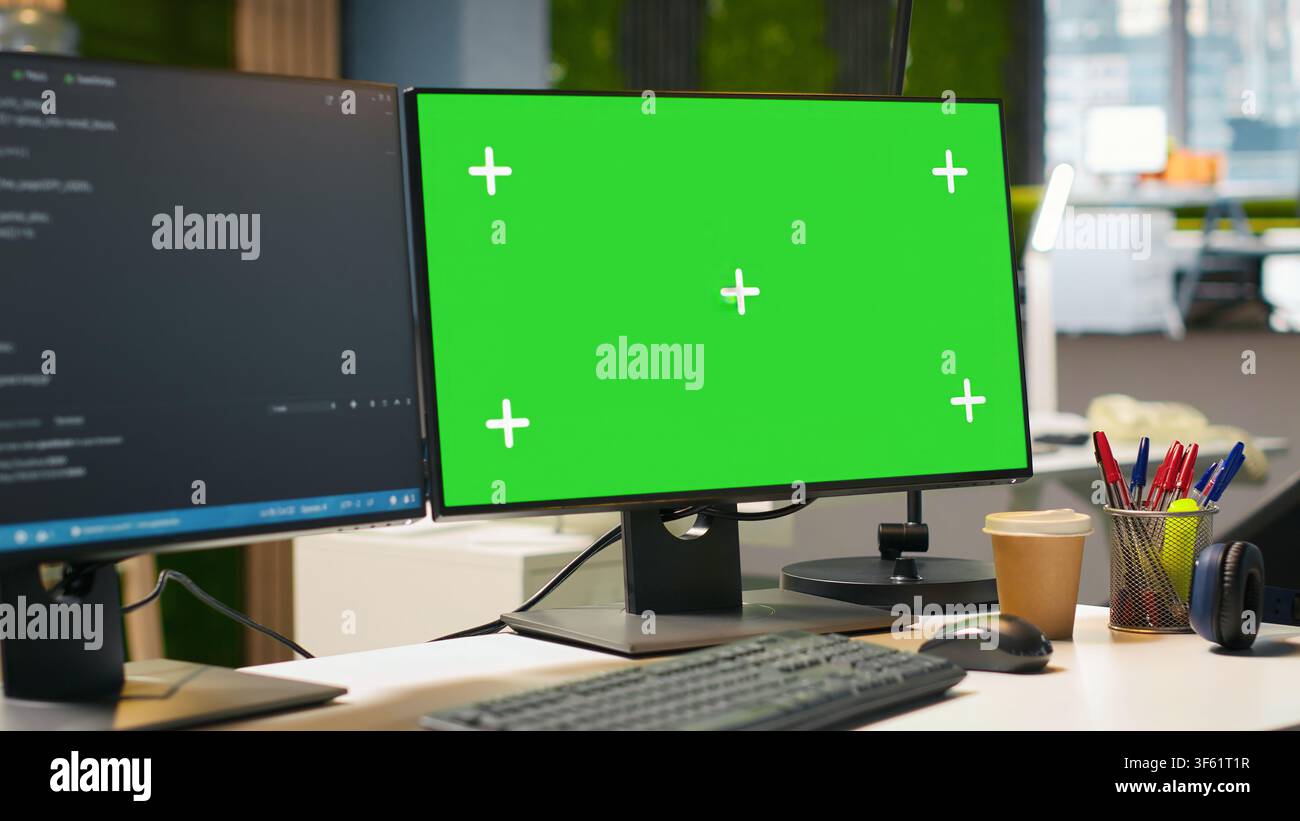 Isolated screen computer monitor in modern startup office displaying code snippets in various programming languages used for application development. Mockup PC in empty software agency workspace Stock Photo