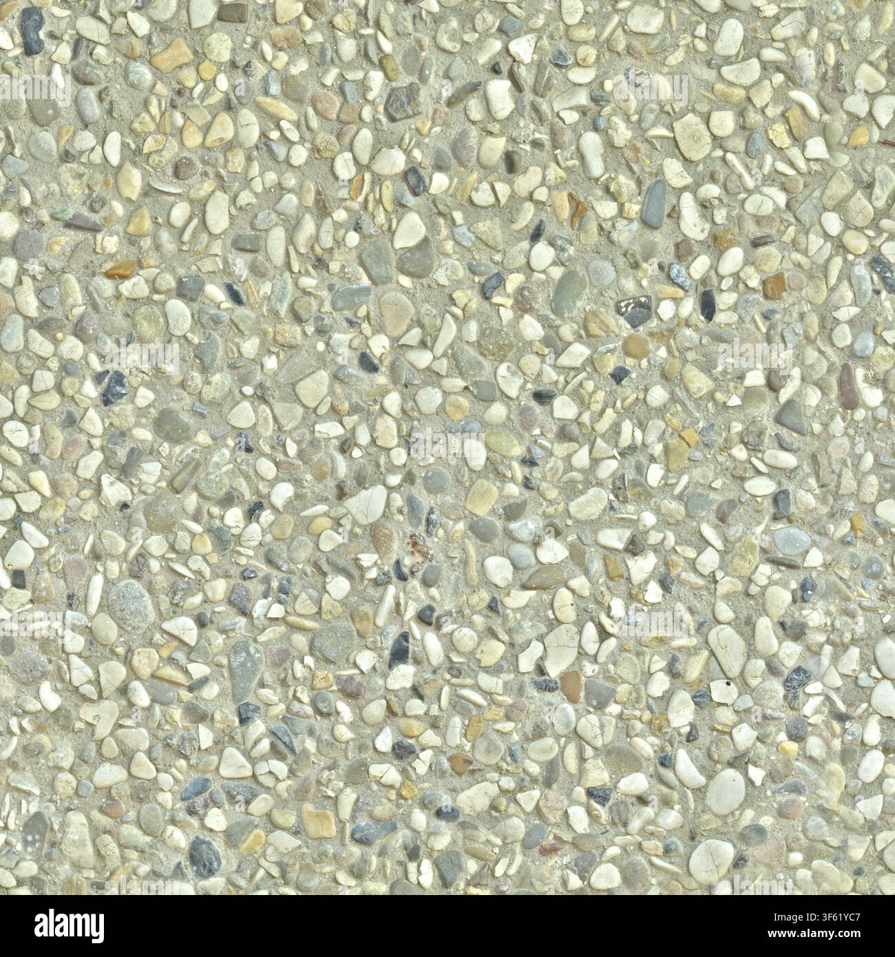 Light beige washed concrete surface with packed small rounded river pebbles. Stock Photo