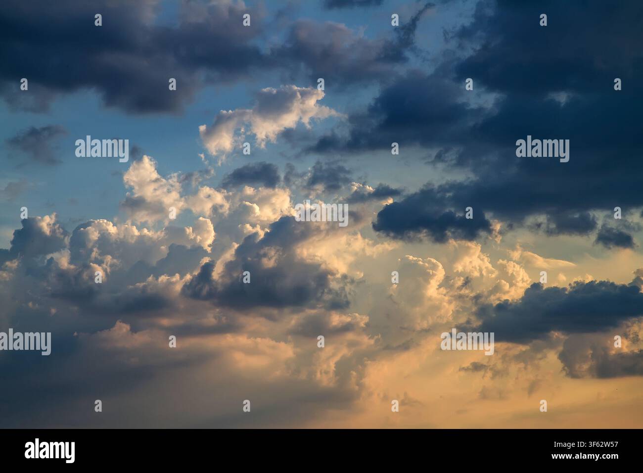 Dramatic evening sky with cumulus clouds. Stock Photo